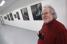 Javier Sueskun Posa Junto A Varios De Sus Cuadros.