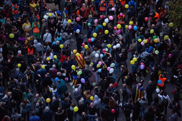 Manifestantes tiran globos al aire frente a la Conselleria de Interior en Barcelona